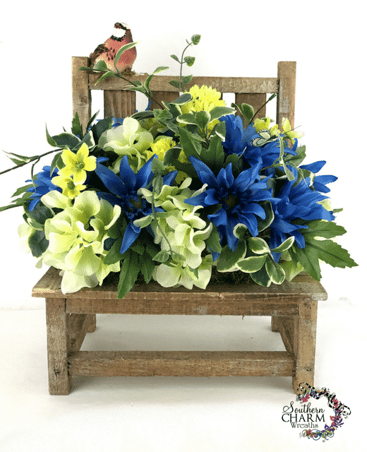 In this video, create a DIY Summer Silk Flower Arrangement for your home using a wooden bench.