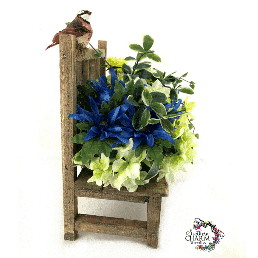 In this video, create a DIY Summer Silk Flower Arrangement for your home using a wooden bench.