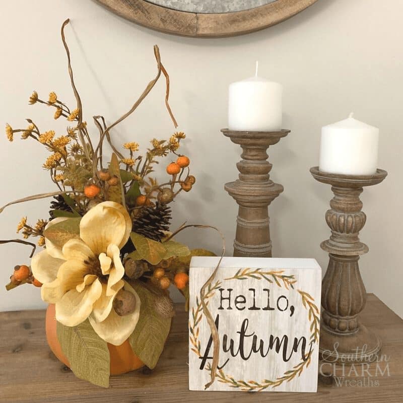 pumpkin planter and hello autumn sign on a table