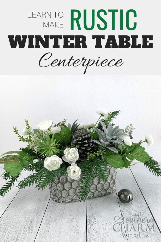 "Learn to make a Rustics Winter Table Centerpiece" Rustic winter floral centerpiece. Metal honeycomb basket with, greenery, pinecones, succulents, and white flowers. 