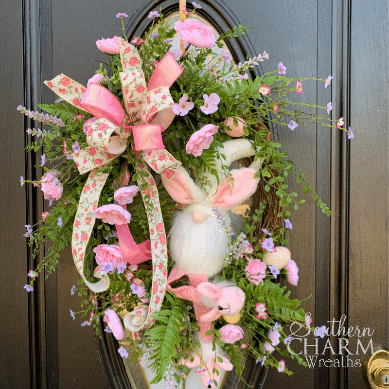 pink and green silk flower wreath with gnome and ribbon bow for Easter decor