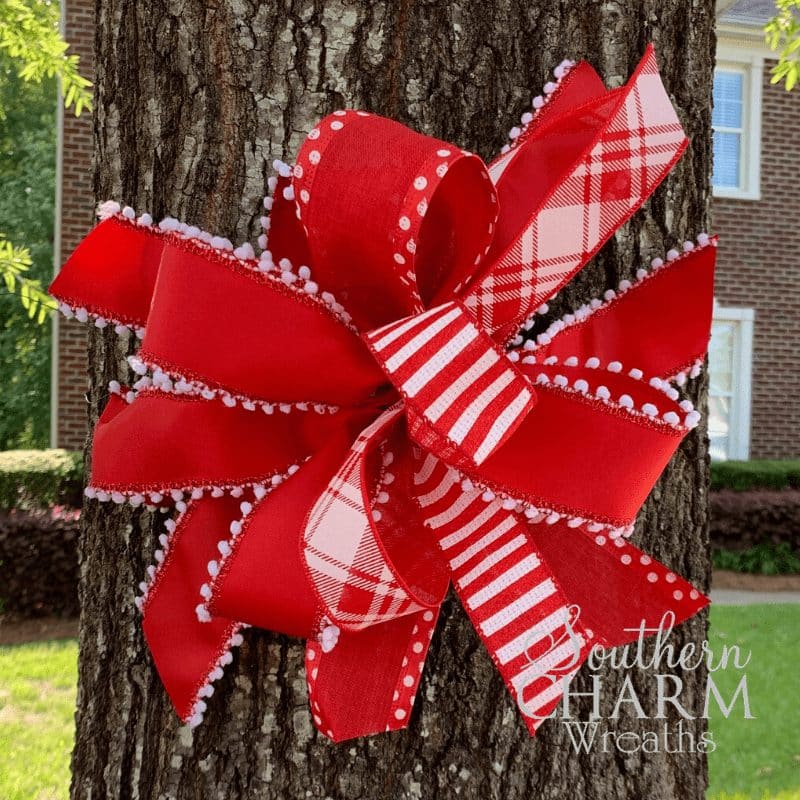 red ribbon bow showing unity and support for healthcare workers