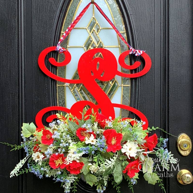 Red monogram door hanger with red white and blue flowers