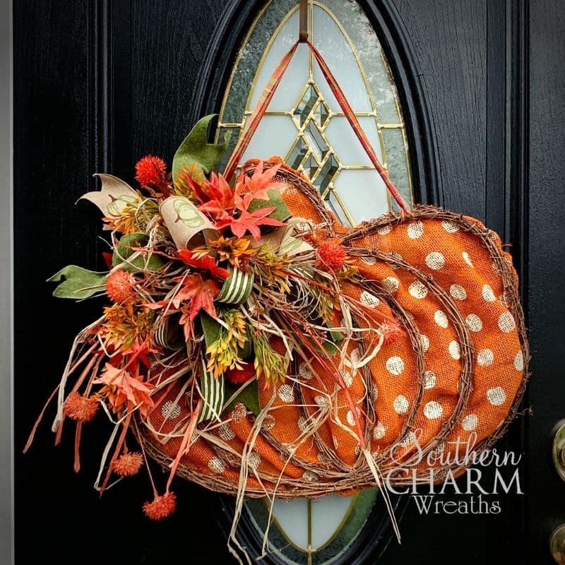 fall pumpkin door hanger on a black door