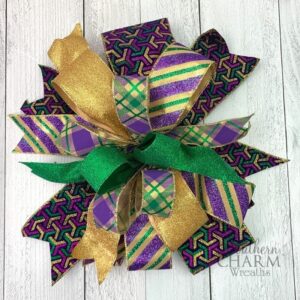 Green, purple, and gold multi ribbon bow with glittery ribbons