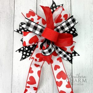 Multi ribbon bow with red ribbon, black and white checkered ribbon, ribbon with red hearts, and black and white polka dot ribbon