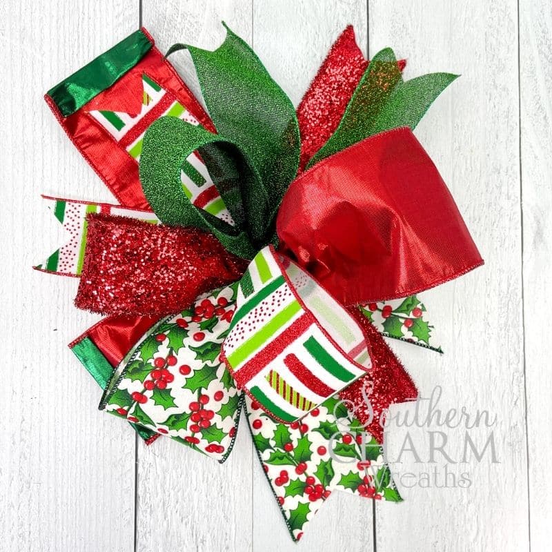 A funky Christmas bow with ribbons of different sizes 