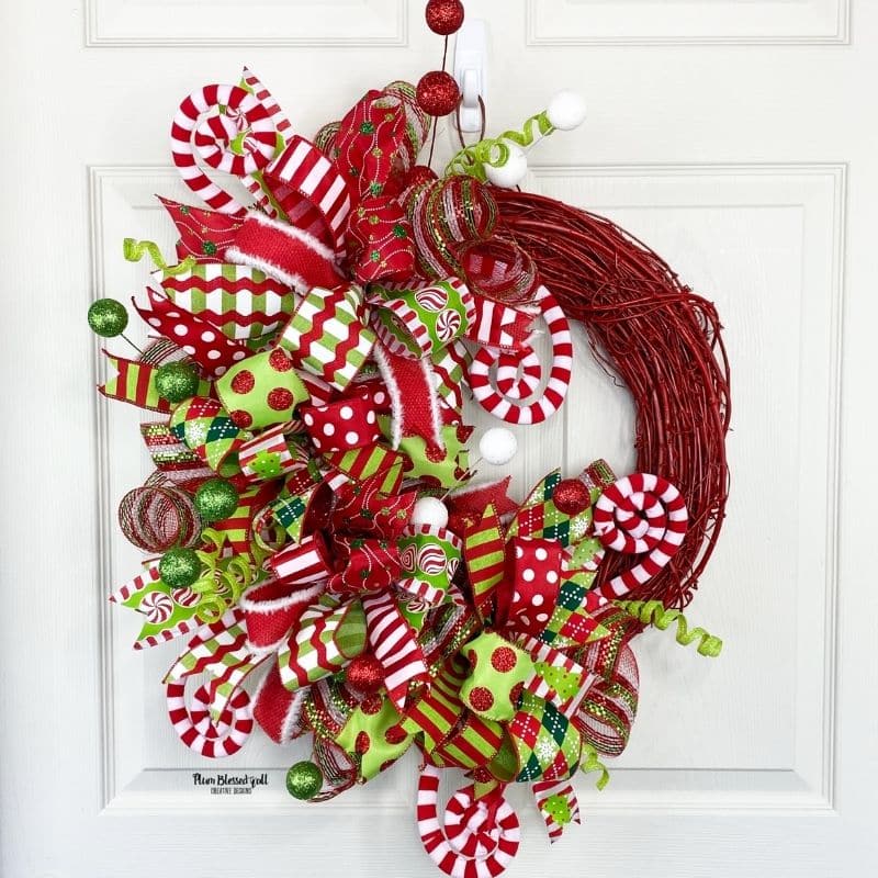 Red grapevine Christmas Wreath on white door
