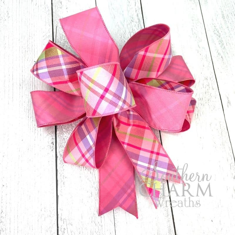 pink and plaid double sided ribbon on white background