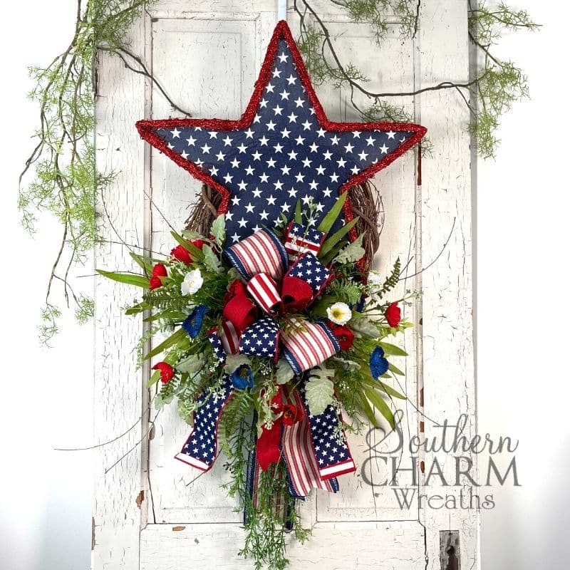 red white and blue patriotic wreath with blue star on white door