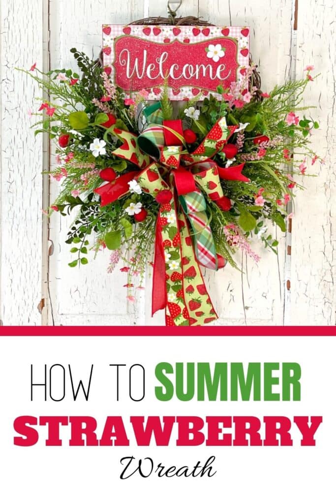 green and red strawberry themed wreath on white door