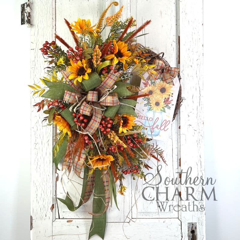 hello fall grapevine wreath with sign on white door.