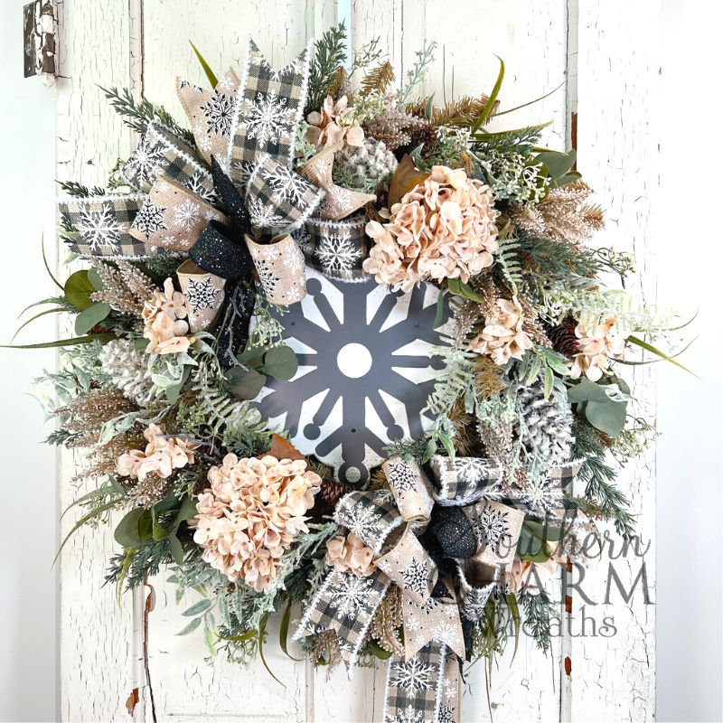 full burlap and greenery wreath with snowflake center