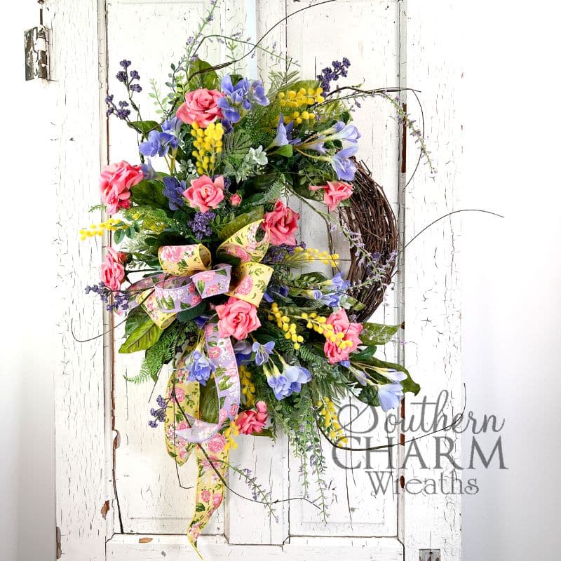 spring rose grapevine wreath on white door