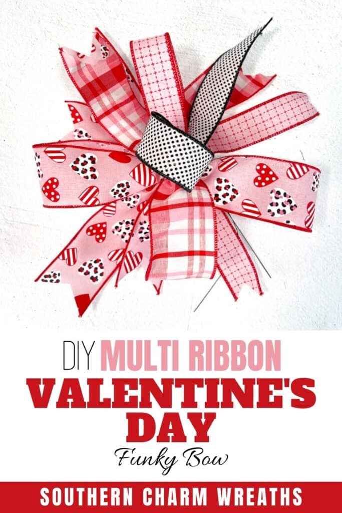 red bow with hearts and black ribbon on white background