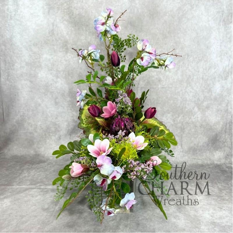 artichoke magnolia arrangement on gray background