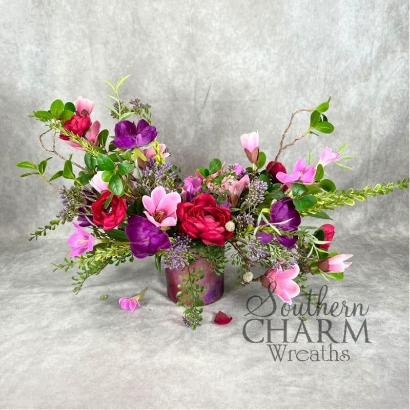 fuchsia foiled container arrangement on gray background
