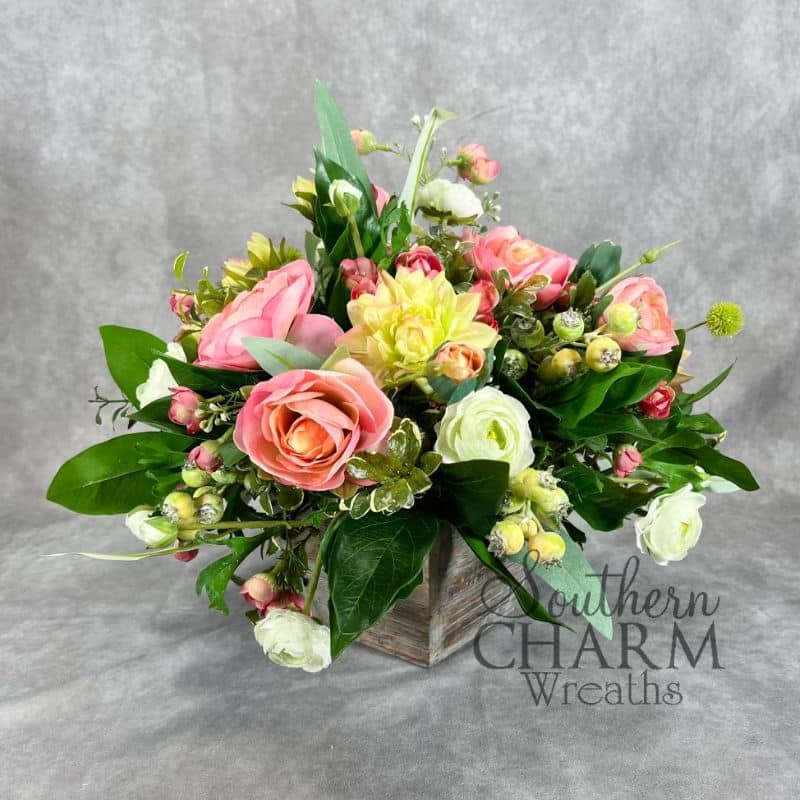 round ranunculus dahlia arrangement on gray background