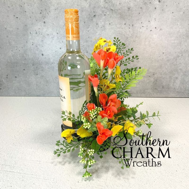 spring flower wine bottle bouquet on gray background