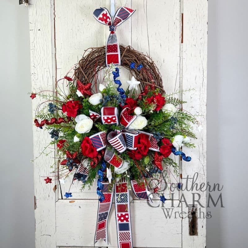 patriotic geranium blueberry wreath on white door