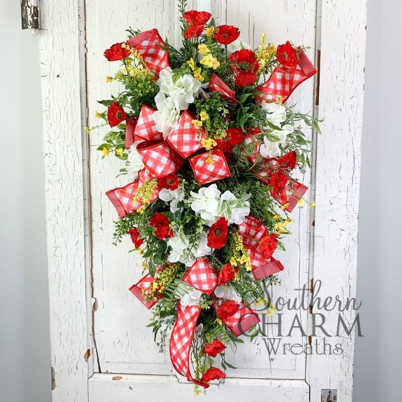 red and white swag wreath on white door