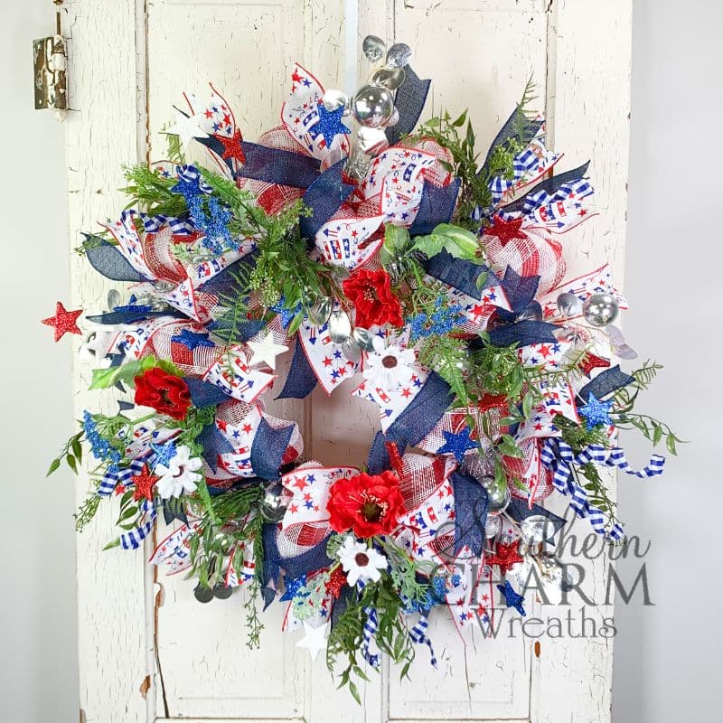 patriotic deco mesh wreath with poppies on white door