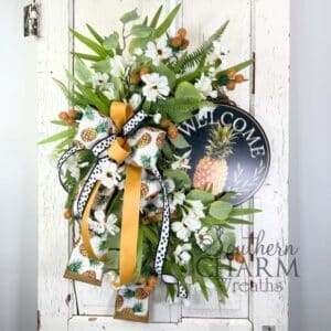 pineapple themed welcome wreath on white door