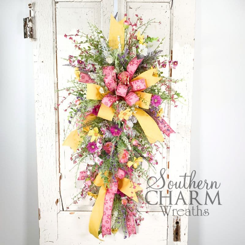 daisy and ranunculus summer swag wreath on white door