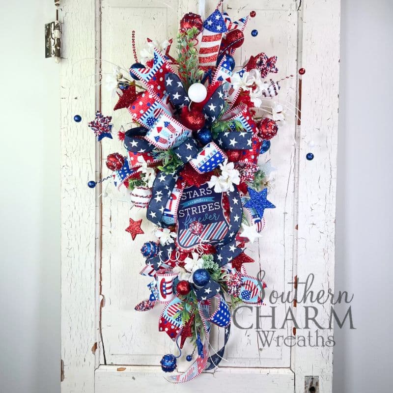red white and blue patriotic swag wreath on white door