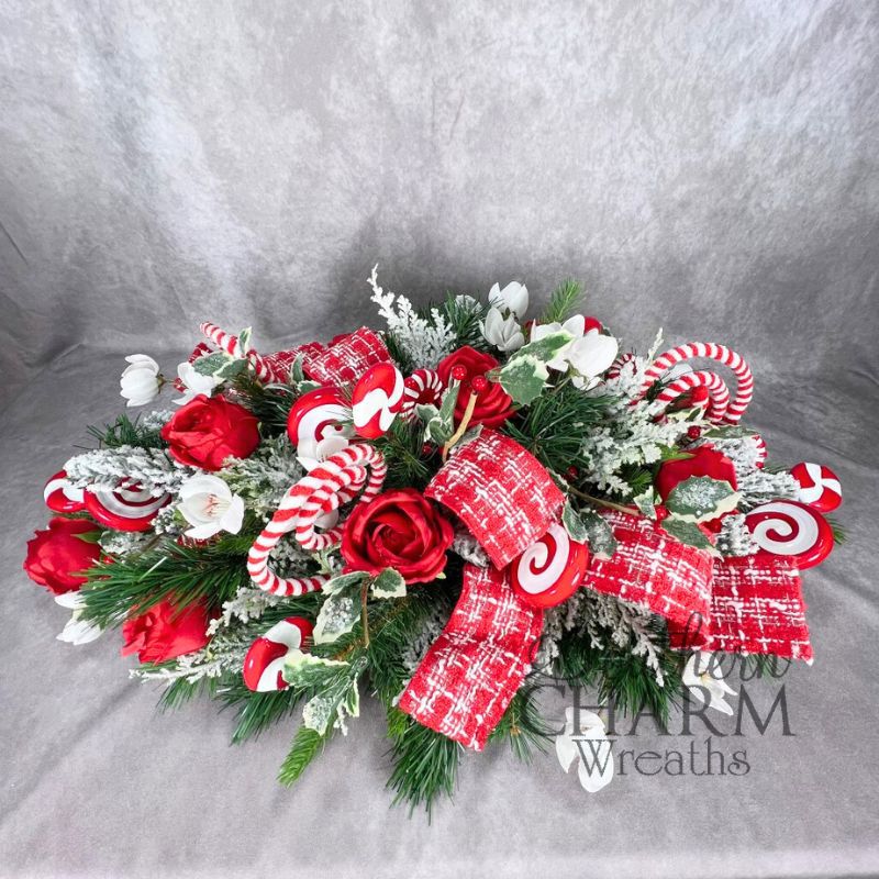 holiday table arrangement with red and white peppermint design