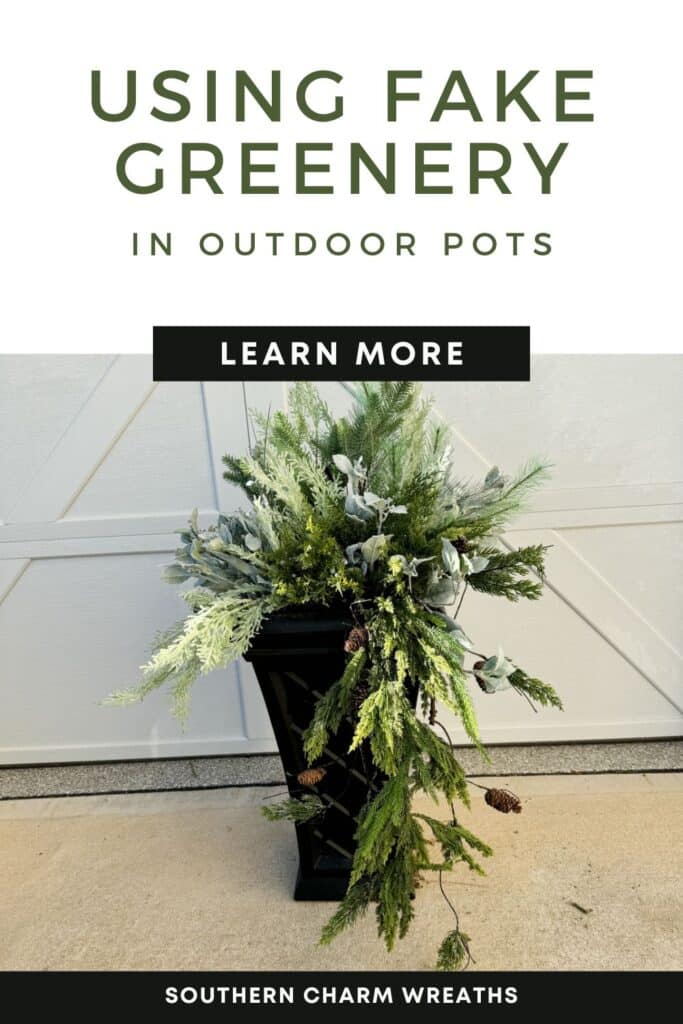 using fake greenery in outdoor pots pinterest pin with image of black planter in front of white garage door