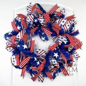 red white and blue patriotic deco mesh wreath on a door