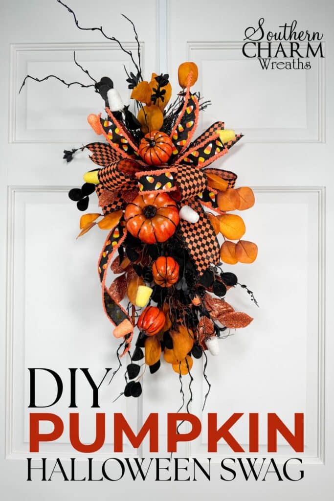 Handmade Halloween swag with pumpkins, candy corn ribbon, and black glittered greenery perfect for front door or lantern decoration.