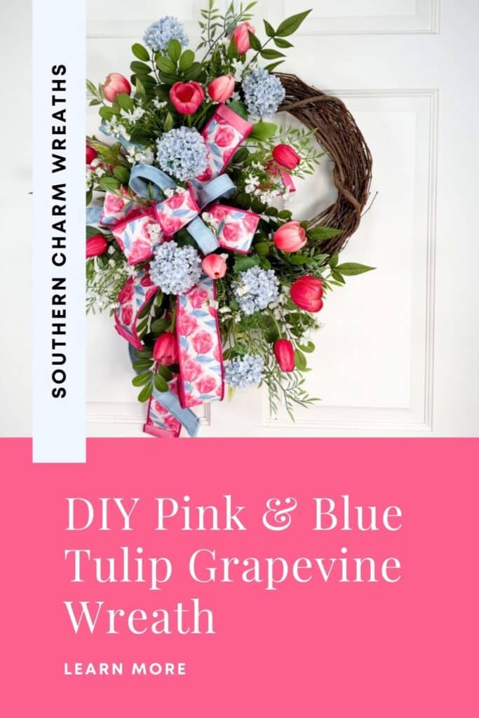 Handmade pink and blue tulip grapevine wreath with a floral ribbon bow, hydrangeas, and mixed greenery on a white door.