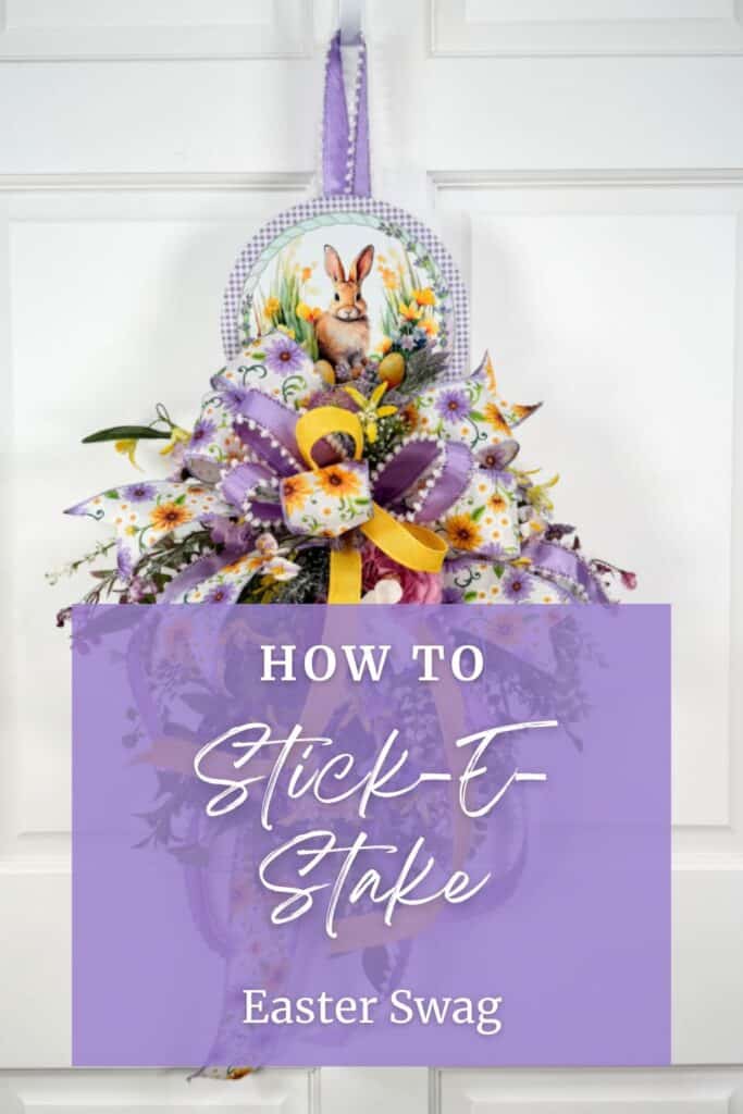 DIY Easter swag wreath made with a bunny Stick-E-Stake sign, purple ribbon bow, yellow accents, and spring florals arranged vertically on a front door.