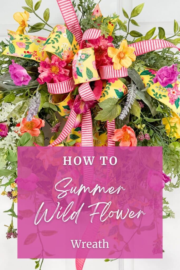 Close-up of a summer wildflower wreath showing hot pink dahlias, yellow cosmos, coral poppies, purple lisianthus, and mixed trailing greenery on a grapevine base. A layered bow in yellow floral-print ribbon and pink-and-white stripe ribbon sits at the top center. A semi-transparent hot pink overlay at the bottom reads: How to Summer Wild Flower Wreath in white script and serif text.