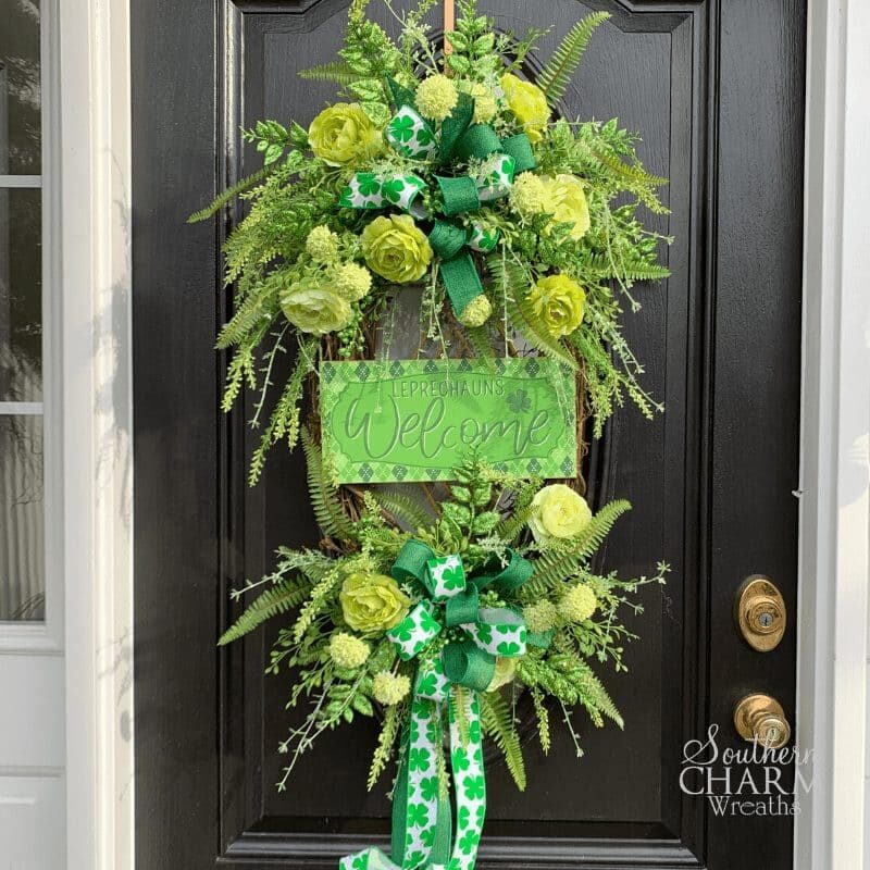 How to make a Green St Patrick's Day Wreath with Welcome leprechauns sign, silk flowers, and greenery by Southern Charm Wreaths #diy #wreath #oval #doordecor #shamrock