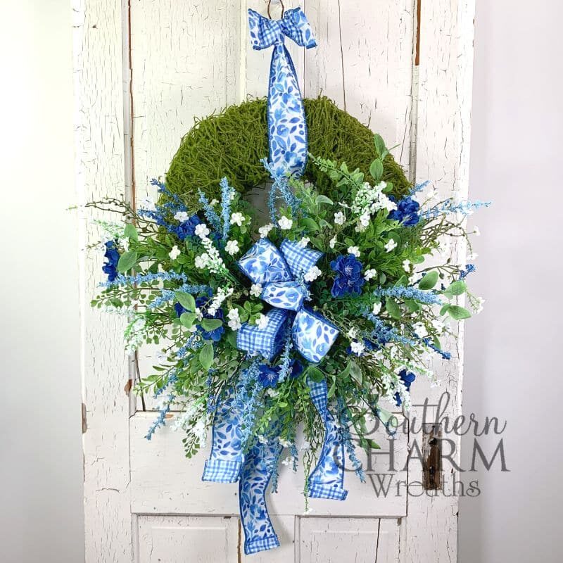blue and white summer moss wreath on white door