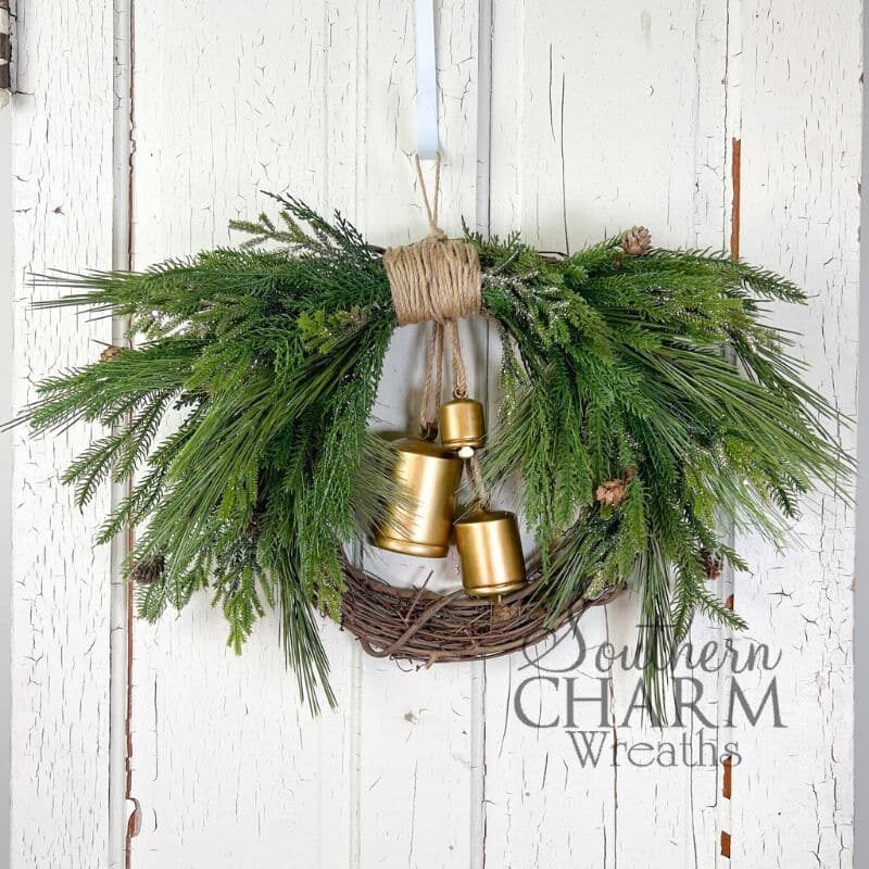 beautiful hanging greenery wreath with gold bells