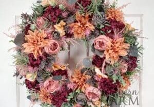 fall pink and orange compact wreath on white door