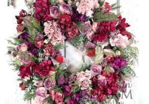 magenta valentine wreath on white door