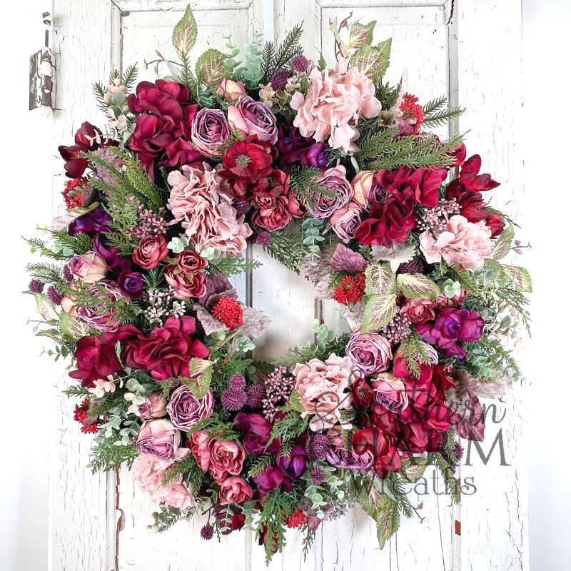 magenta valentine wreath on white door