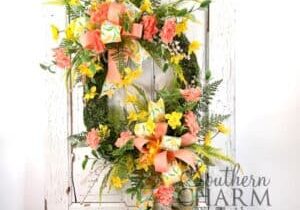 oval moss spring daffodil wreath on white door