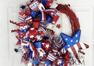 red white and blue themed patriotic wreath on red grapevine