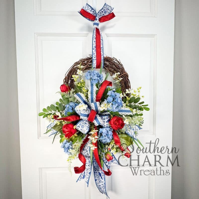 red white and blue patriotic hydrangea wreath for summer hanging on a door