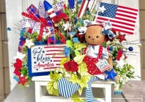Everbloom - Patriotic Doll on Bench Arrangement