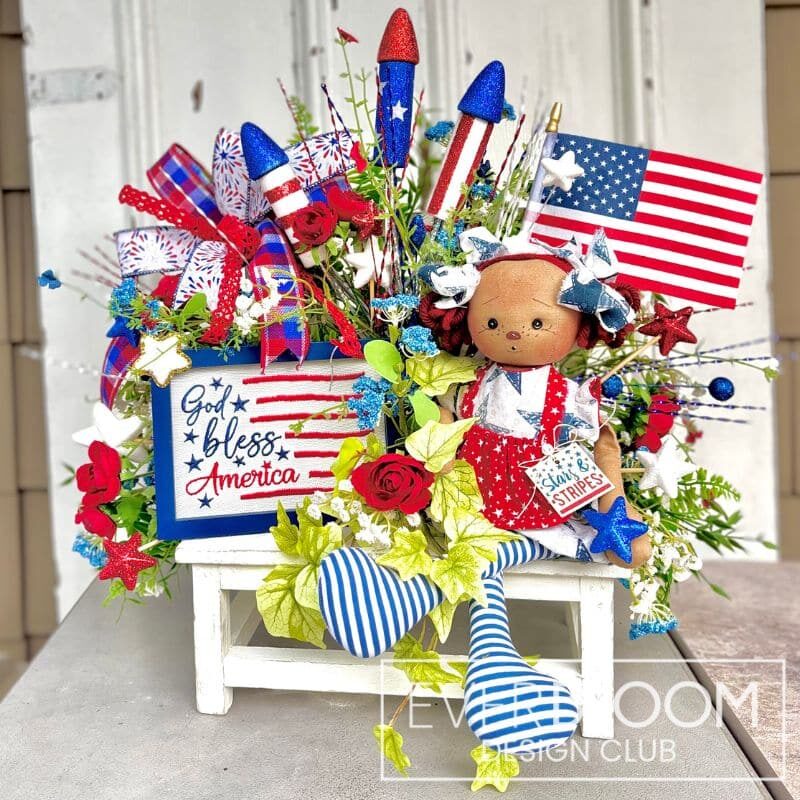Everbloom - Patriotic Doll on Bench Arrangement