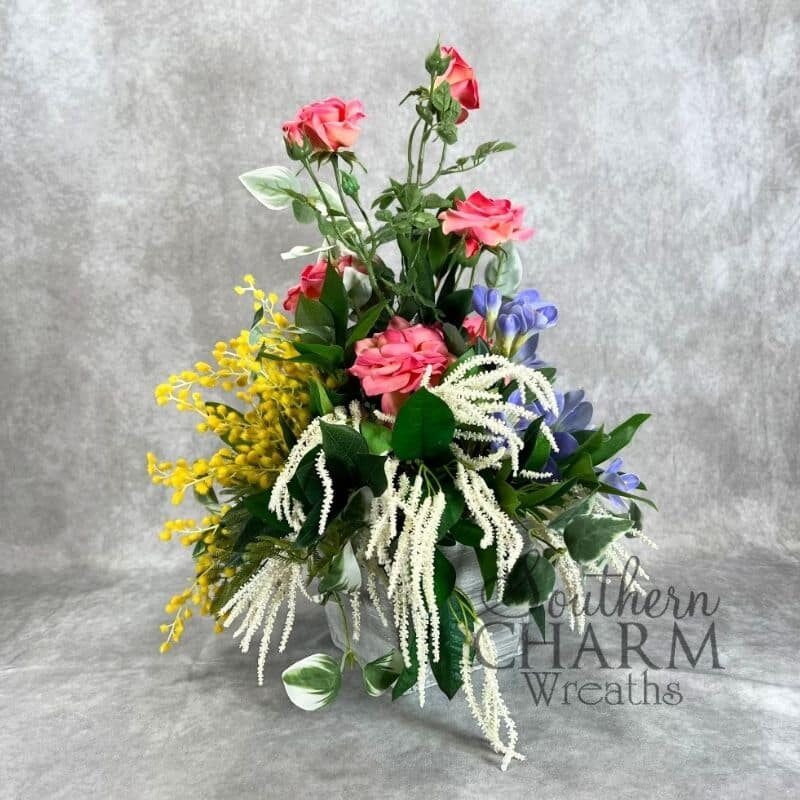 symmetrical garden rose arrangement on gray background