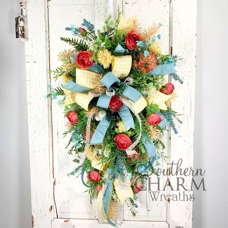 summer floral ranunculus swag wreath on white door
