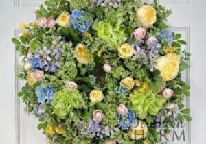 spring wreath on an evergreen wreath base